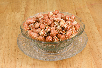 Crispy Sugared peanut with sesame on crystal dish