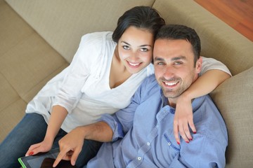 couple at home using tablet computer