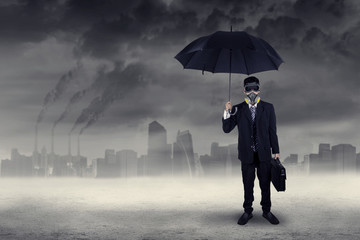 Businessman standing outdoors under air pollution