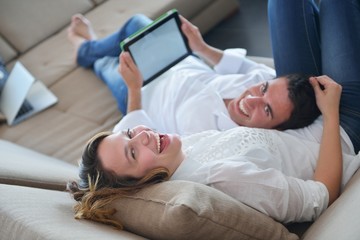 Obraz na płótnie Canvas couple at home using tablet computer