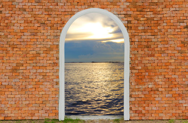 Entrance to ocean of door on wall brick twilight sky