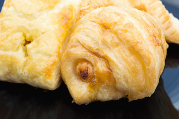 sausage buns on a black plate closeup