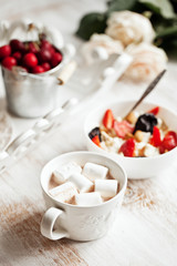 Healthy breakfast with cottage cheese, cacao, cherry and croissa