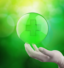 Obraz premium medical hand with globe select on first aid sign