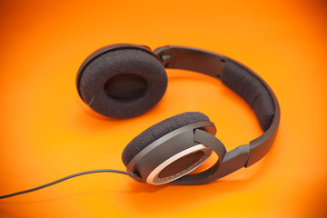 headphones on an orange background