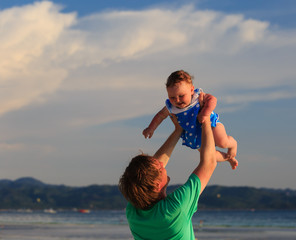 family playing on tropical beach