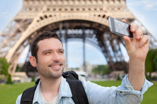 Young attractive tourist taking selfie in Paris