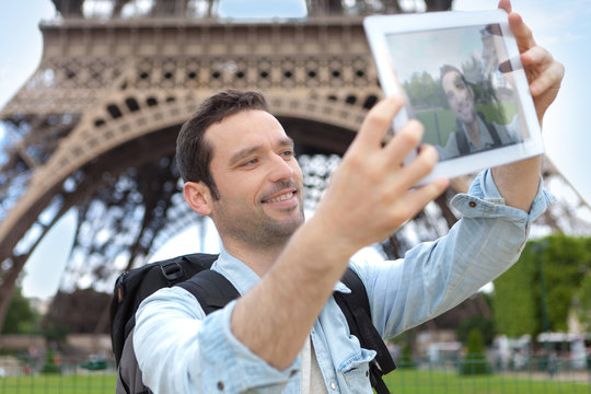 View of Young attractive tourist taking selfie in Paris