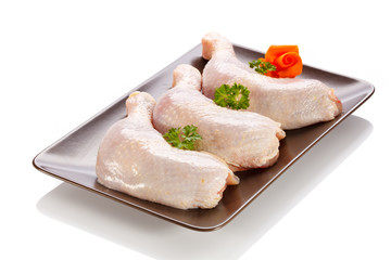 Raw chicken legs on white background