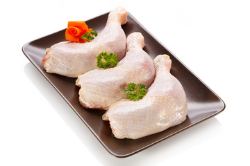 Raw chicken legs on white background