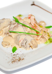 Meat with mushroom in white sauce on plate restaurant menu