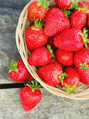 basket with strawberries on a wooden table