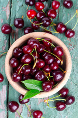 cherries in a bowl on wooden surface