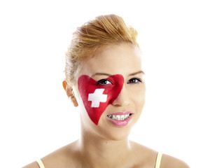 smiling girl with swiss flag painted on her face