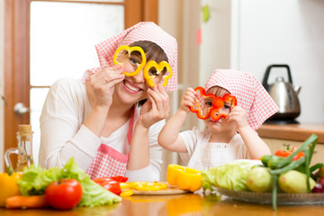 mother and kid preparing healthy food and having fun