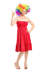 Young girl with wig pointing up with finger