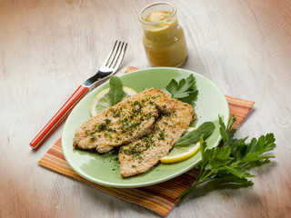 breaded cutlet with herbs and mustard