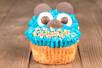 Delicious cupcake over a wooden background