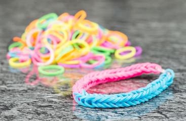 Rubber band bracelet on reflective background