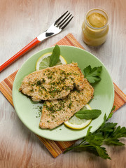 breaded cutlet with herbs and mustard