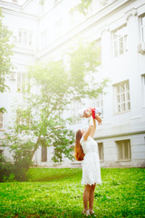 Young mother playing with daughter in summer park