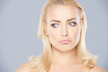 Thoughtful young woman grimacing