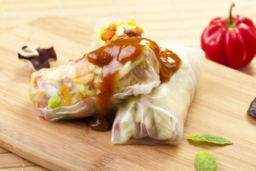 Portion of spring rolls on a bamboo board