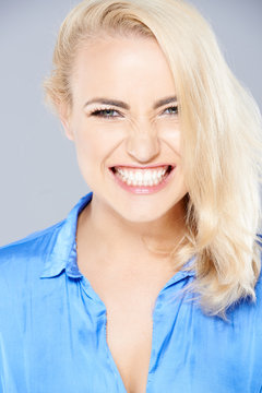 Beautiful blond woman gnashing her teeth