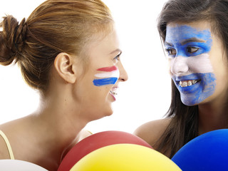 dutch and argentinian flags painted on girls' faces