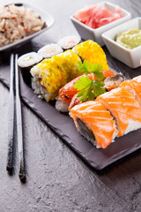 Delicious sushi pieces served on black stone