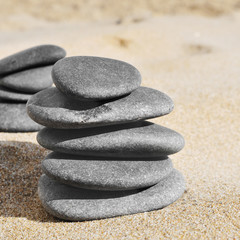 Fototapeta na wymiar stacks of stones on the sand of a beach