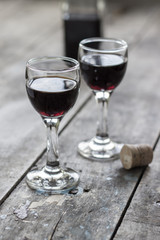 glass of cherry liqueur on wooden table