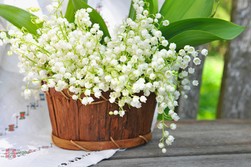 Basket with lilies of the valley (Convallaria majalis)