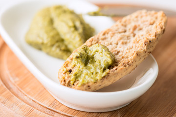 Toast with pesto sauce in bowl