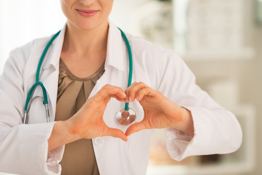 Closeup on medical doctor woman showing heart shape gesture