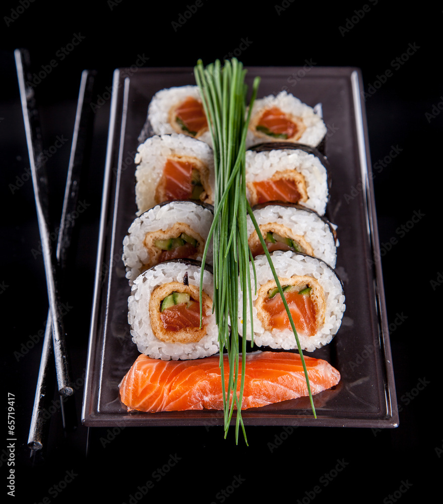 Poster Delicious sushi pieces on black background