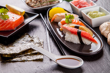 Delicious sushi pieces served on black stone