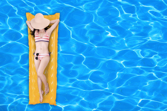 Woman Floating On A Pool Mattress 1