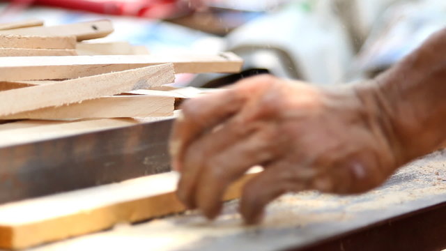 Carpenter cutting wood by electric saw,Without safety guard.