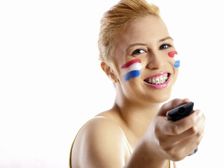 smiling girl with dutch flag painted on her face