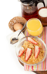 Breakfast including orange juice, muesli and fruits