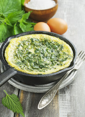 Omelet with nettles in the pan