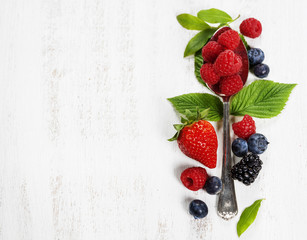 Berries with spoon  on Wooden Background. Health, Diet, Gardenin