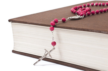 red rosary on a book
