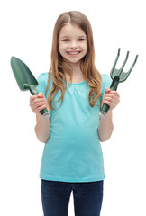 smiling little girl with rake and scoop