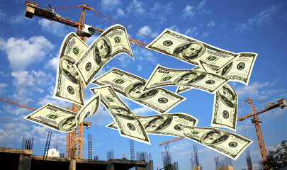 Falling notes of US dollar against cranes