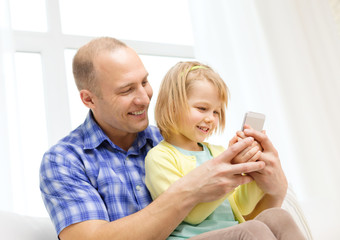 happy father and daughter with smartphone