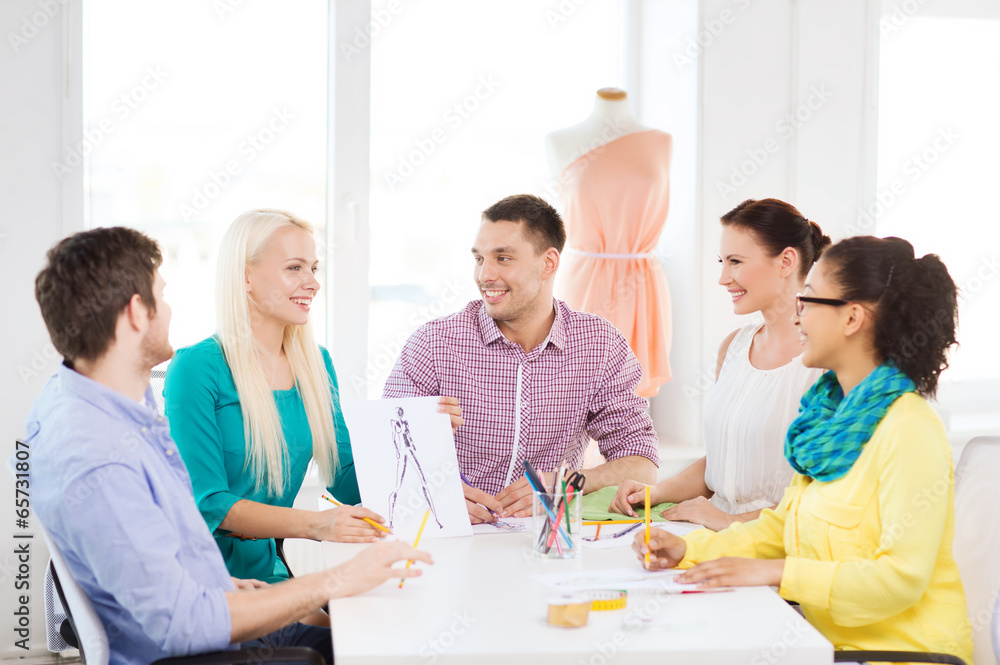 Poster smiling fashion designers working in office