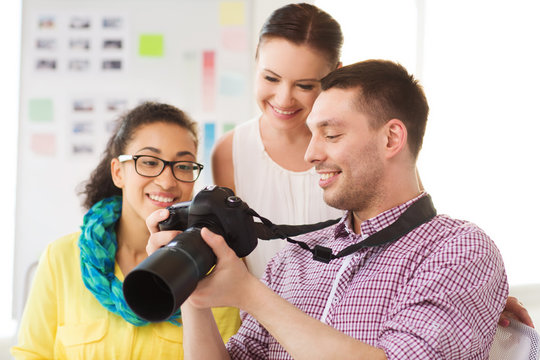 Smiling Team With Photocamera Working In Office