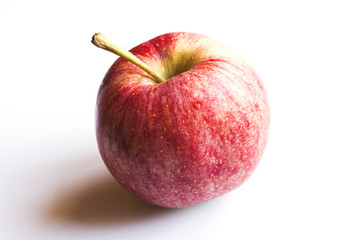 A shiny red apple isolated on a white background